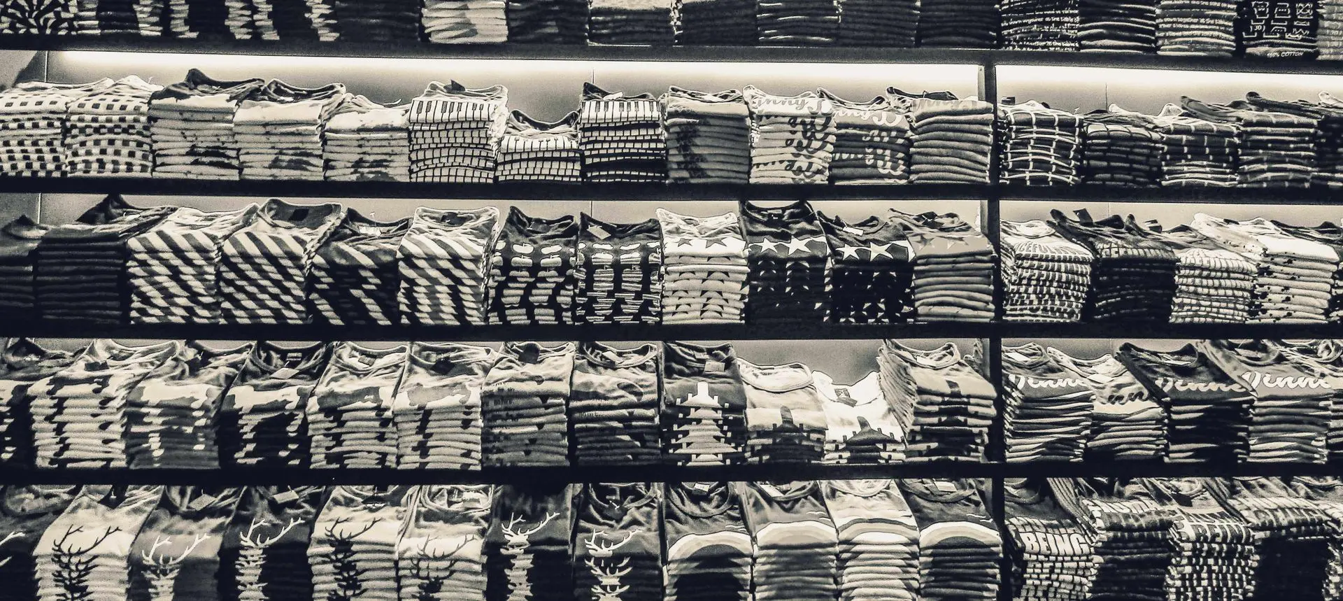 Shelves of folded t-shirts