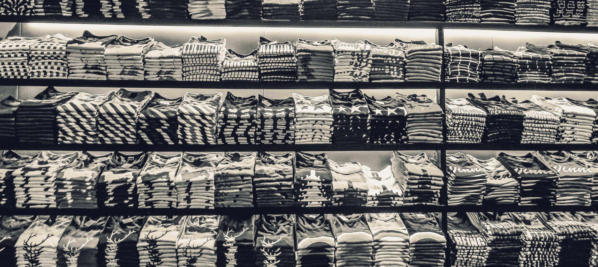Shelves of folded t-shirts