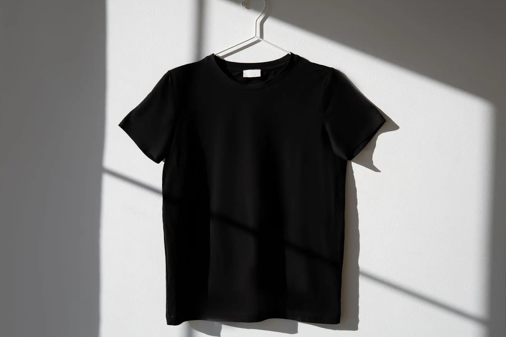 Blank black t-shirt on a hanger
