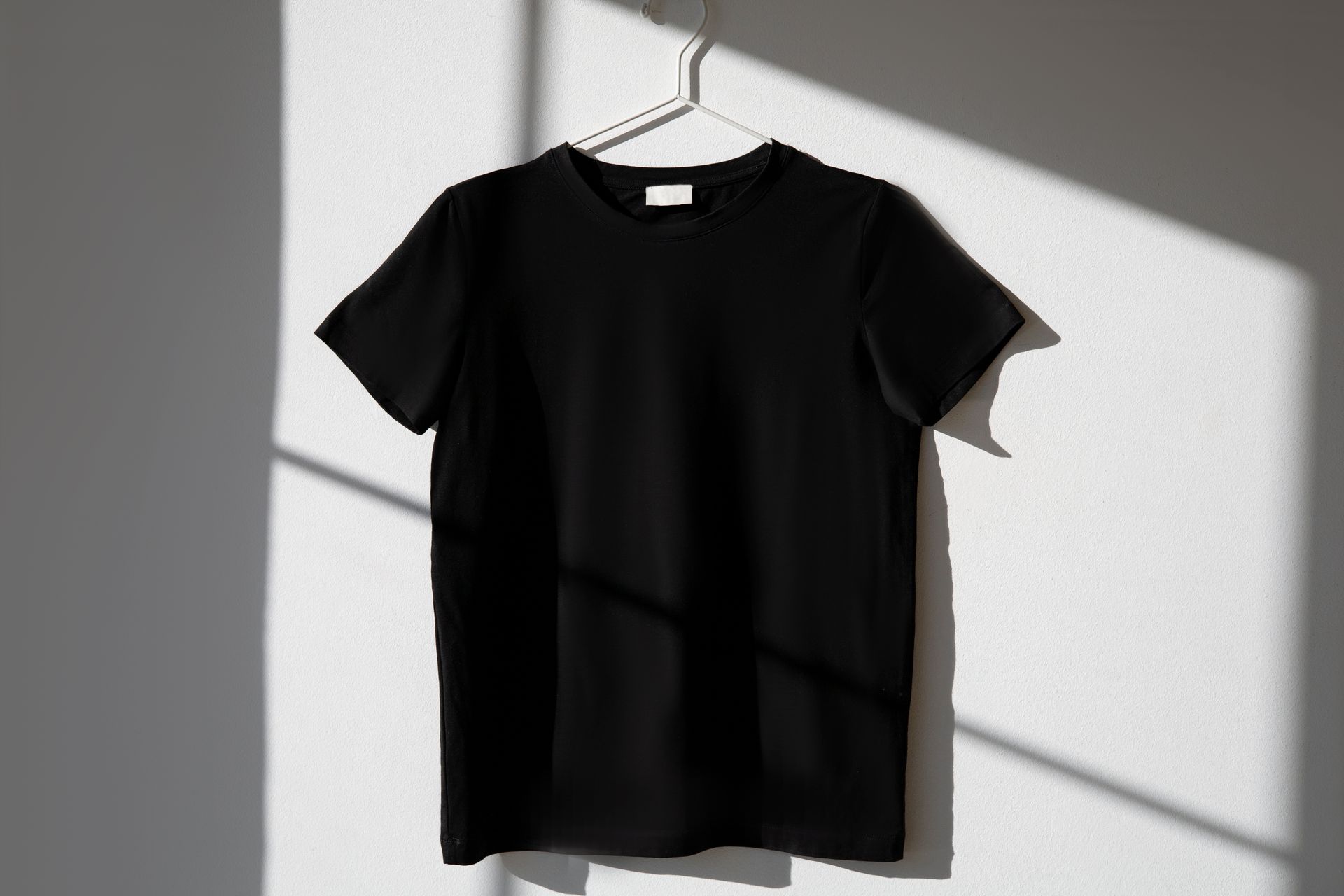 Blank black t-shirt on a hanger